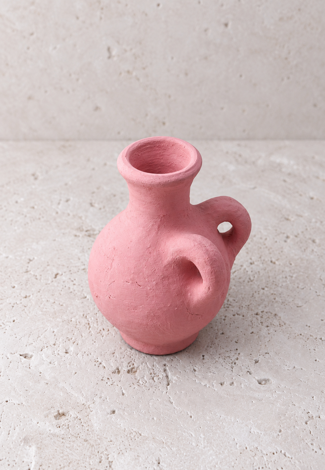 Detail of the sandy matte coral pink surface of the amphora vase